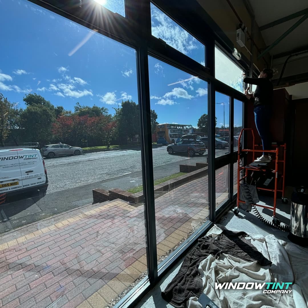 Window Tint Company installing solar film on a commercial shopfront in Scotland